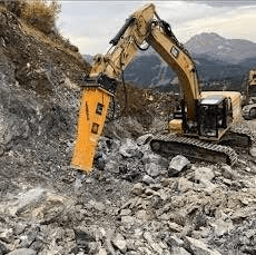 CAT excavator with hydraulic breaker on rock job